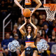 The Phoenix Suns mascot The Gorilla holds a Suns dancer on his shoulders as a member of the Gorilla Dunk Squad does a front flip dunk during a second half against the Cleveland Cavaliers at Talking Stick Resort Arena.
